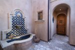A fountain welcomes you to the front door of this hidden oasis